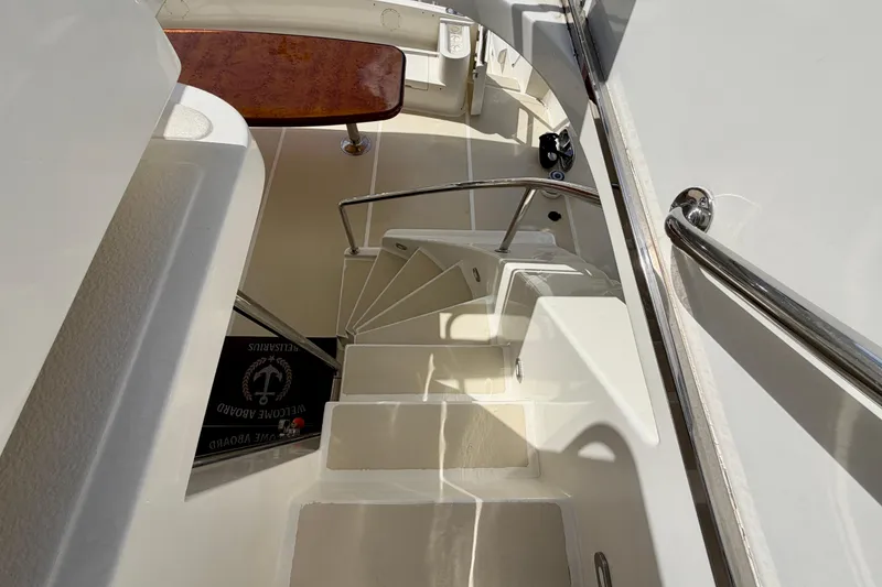 Slide: The Image of Staircase on Horizon 92 yacht with polished wood table and sleek design. - 133