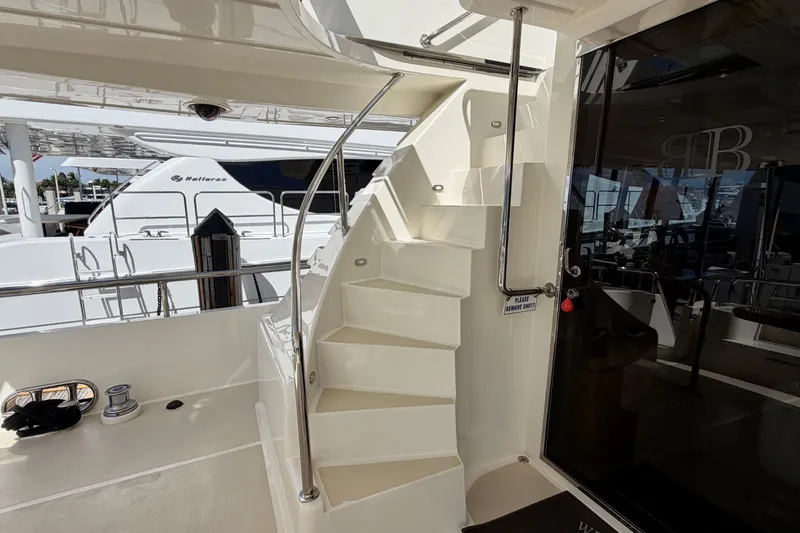 Slide: The Image of Staircase on Horizon 92 yacht leading to upper deck, with sleek design and polished railing. - 134