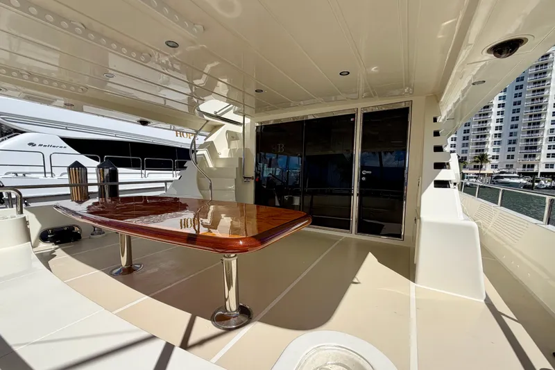 Slide: The Image of Luxurious Horizon 92 yacht deck with polished wooden table and modern design. - 136