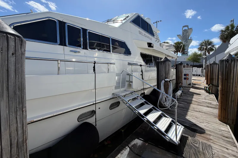 Slide: The Image of Luxury Horizon 92 yacht docked at marina with clear blue sky. - 147
