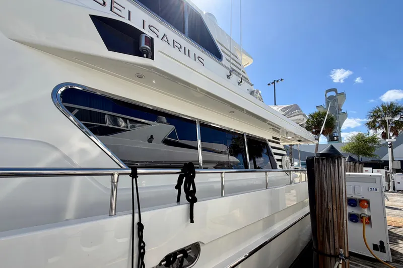 Slide: The Image of Luxury Horizon 92 yacht docked at marina under clear blue sky. - 148