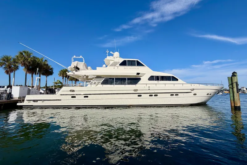 Slide: The Image of Luxury Horizon 92 yacht docked, clear blue sky, palm trees in background. - 149