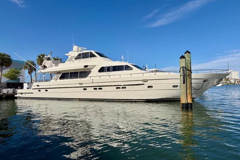 Slide: The Image of Luxurious Horizon 92 yacht docked in sunny marina, clear blue sky backdrop. - 150