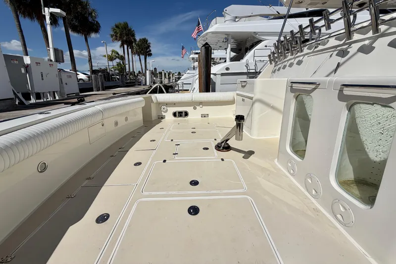 Slide: The Image of Spacious deck of Horizon 92 yacht docked at marina with palm trees and blue sky. - 17