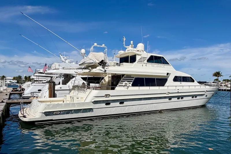 Slide: The Image of Luxury Horizon 92 yacht docked at marina under clear blue sky. - 2