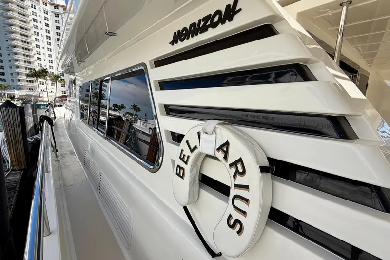 Slide: The Image of Luxury Horizon 92 yacht docked, featuring sleek design and reflective windows. - 24