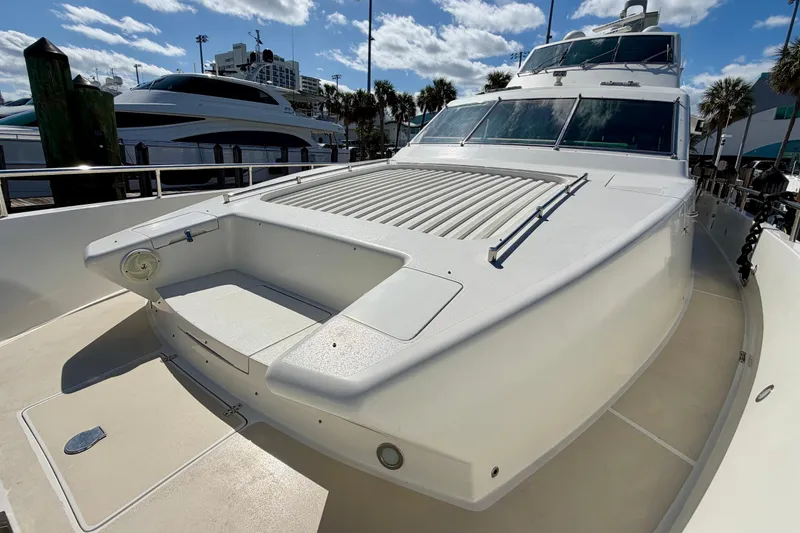 Slide: The Image of Luxury Horizon 92 yacht docked under a sunny sky, showcasing sleek design and spacious deck. - 26