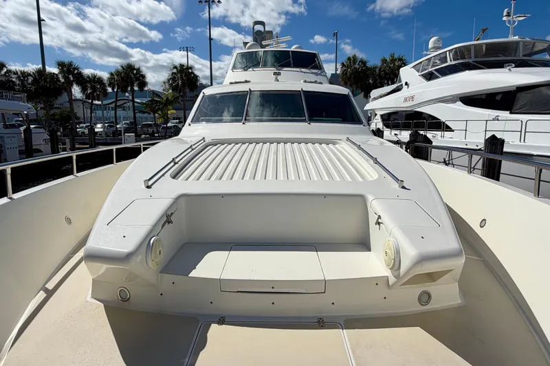 Slide: The Image of Luxury Horizon 92 yacht docked under a sunny sky with palm trees. - 27