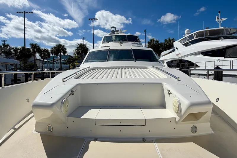 Slide: The Image of Luxury Horizon 92 yacht docked under a bright blue sky with palm trees. - 28