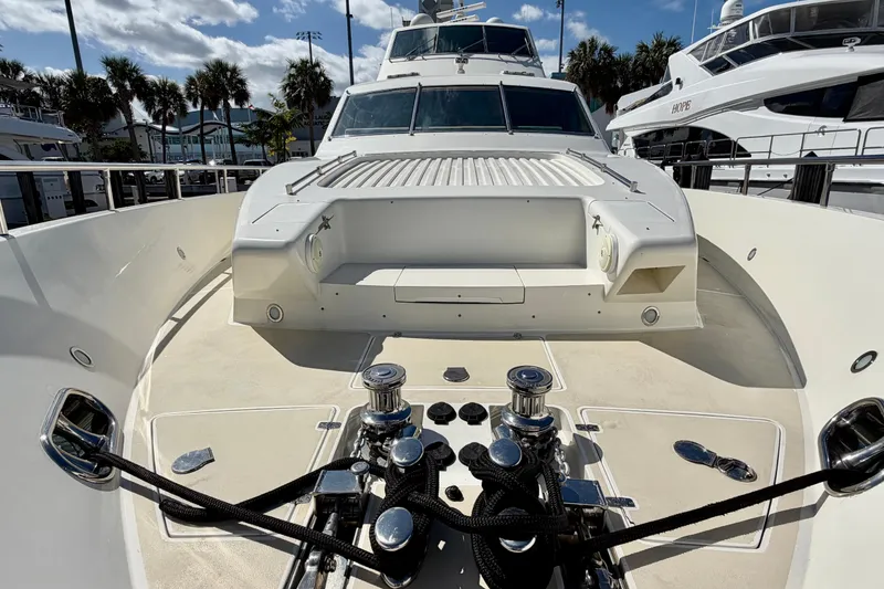 Slide: The Image of Luxury Horizon 92 yacht deck with winches and seating, docked under a sunny sky. - 29