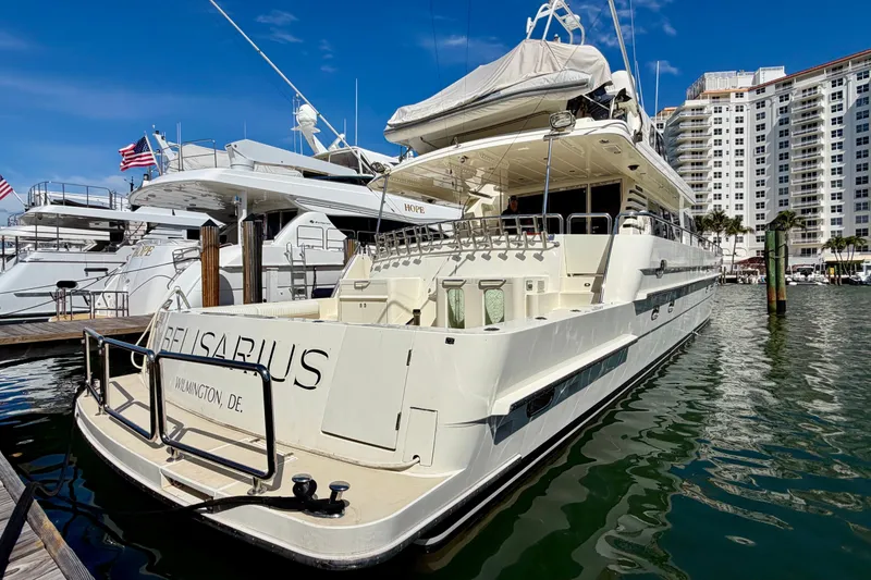 Slide: The Image of Luxury Horizon 92 yacht docked at marina with cityscape background. - 3