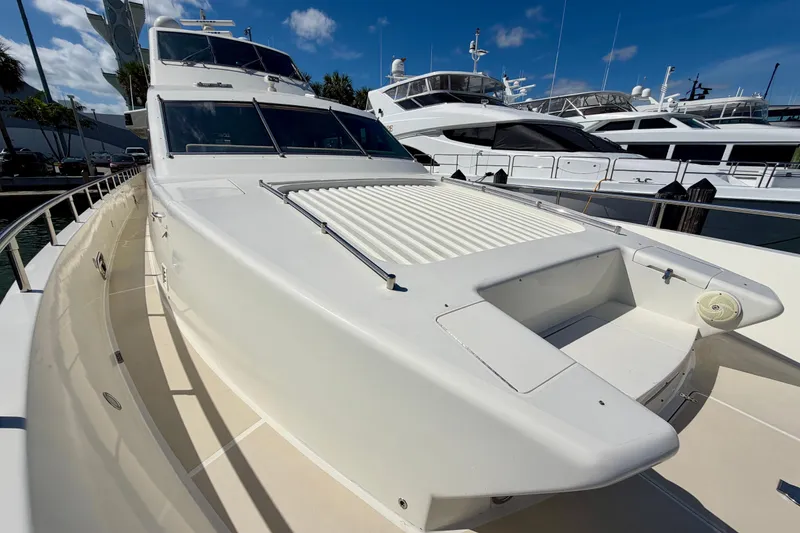 Slide: The Image of Luxury Horizon 92 yacht docked, showcasing sleek design and spacious deck under clear blue sky. - 33