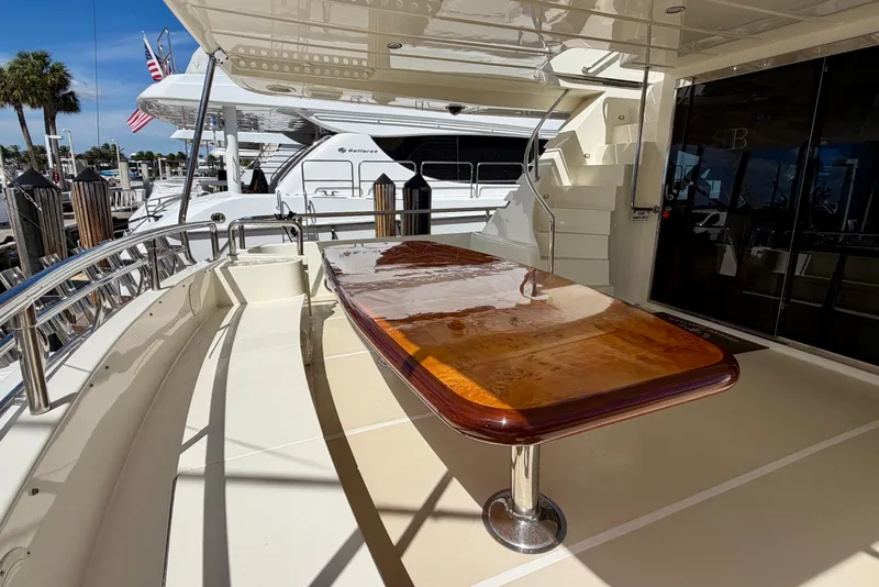 Slide: The Image of Luxurious Horizon 92 yacht deck with polished wooden table and seating area. - 35