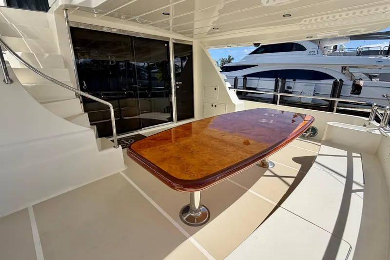 Slide: The Image of Luxurious Horizon 92 yacht deck with polished wooden table and elegant staircase. - 36