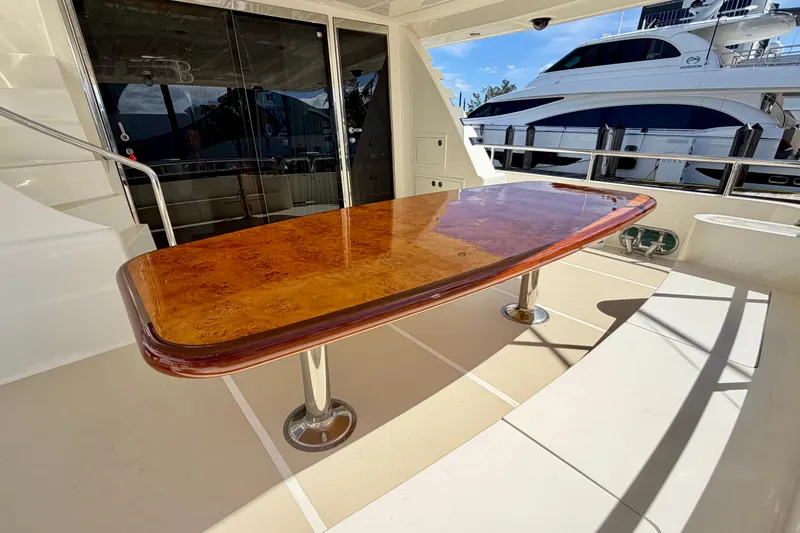 Slide: The Image of Luxurious yacht deck with polished wooden table, Horizon 92 model in marina setting. - 37