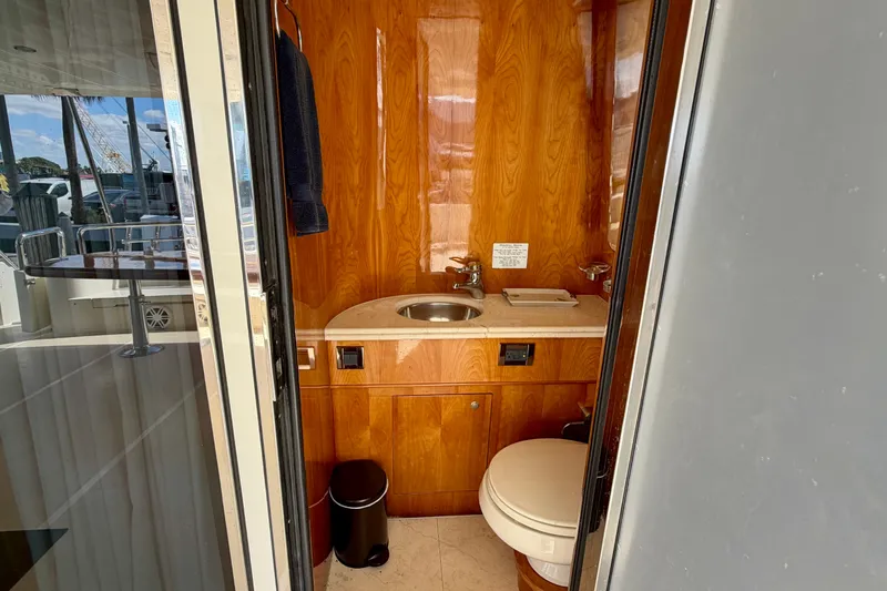 Slide: The Image of Luxurious yacht bathroom with wooden cabinetry, sink, and toilet on Horizon 92 model. - 40