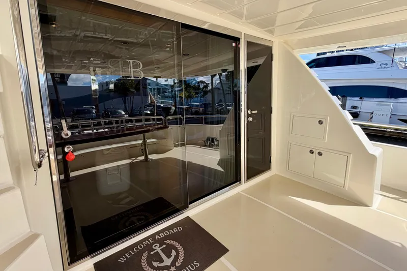 Slide: The Image of Luxury yacht entrance with glass doors, Horizon 92 model, featuring welcome mat and sleek design. - 42