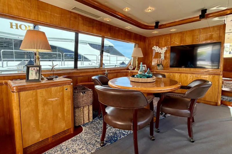 Slide: The Image of Luxurious Horizon 92 yacht interior with wooden decor, round table, and large window view. - 47