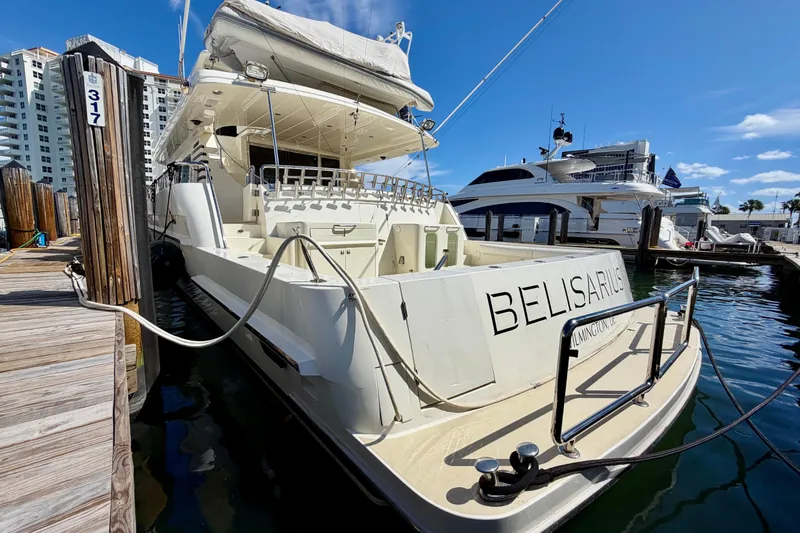 Slide: The Image of Luxury Horizon 92 yacht docked at marina under clear blue sky. - 5