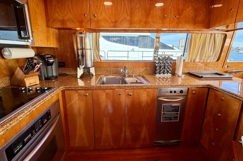 Slide: The Image of Luxurious yacht kitchen with wooden cabinetry, granite countertops, and modern appliances on Horizon 92. - 57