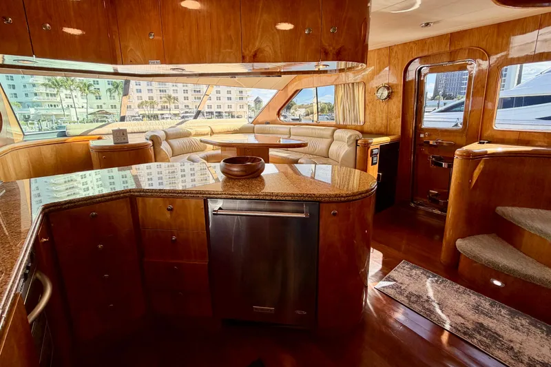 Slide: The Image of Luxurious Horizon 92 yacht interior with polished wood, plush seating, and panoramic windows. - 58