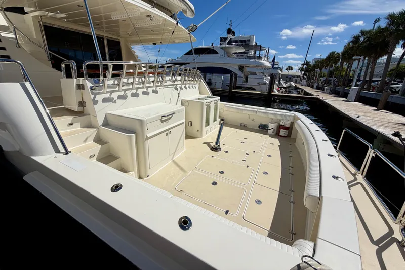 Slide: The Image of Luxurious Horizon 92 yacht deck with seating, docked under a clear blue sky. - 6