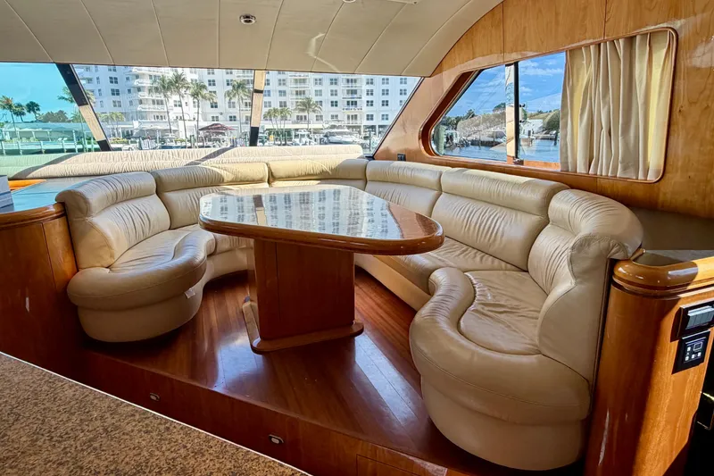 Slide: The Image of Luxurious Horizon 92 yacht interior with plush leather seating and polished wood table. - 60