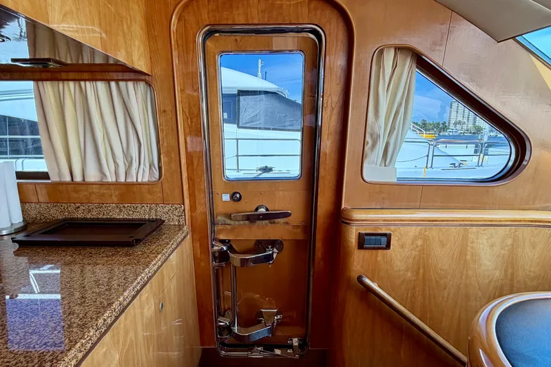 Slide: The Image of Luxurious Horizon 92 yacht interior with wooden finish and granite countertop. - 65