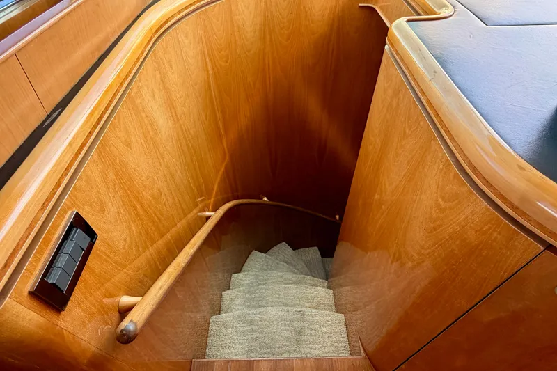 Slide: The Image of Wooden staircase with carpeted steps on a Horizon 92 yacht interior. - 66