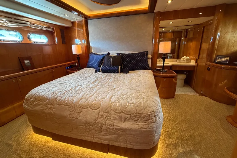 Slide: The Image of Luxurious bedroom interior on Horizon 92 yacht with elegant bedding and wooden accents. - 67