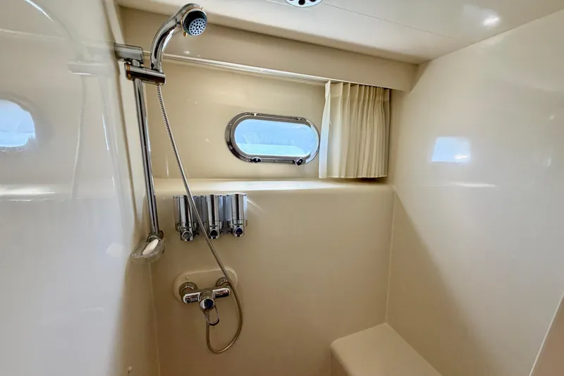 Slide: The Image of Shower area in Horizon 92 yacht with window and curtain. - 77
