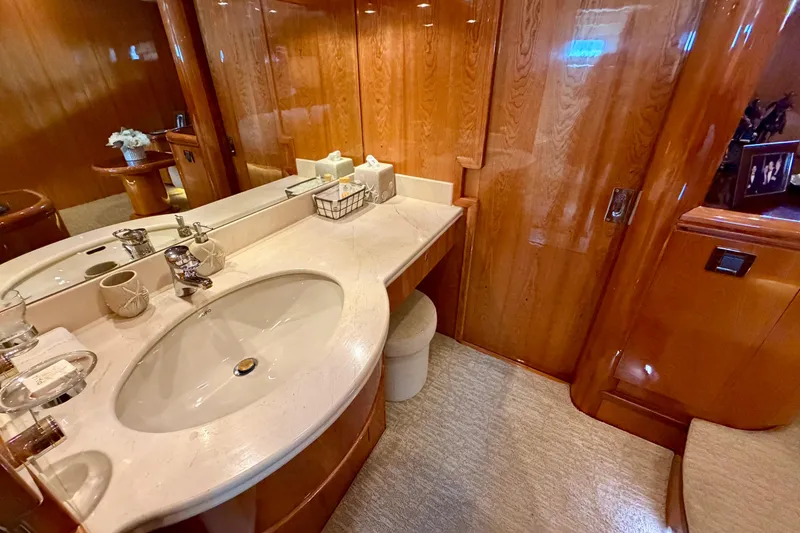 Slide: The Image of Luxurious yacht bathroom with wooden cabinetry and elegant marble sink, Horizon 92 model. - 78