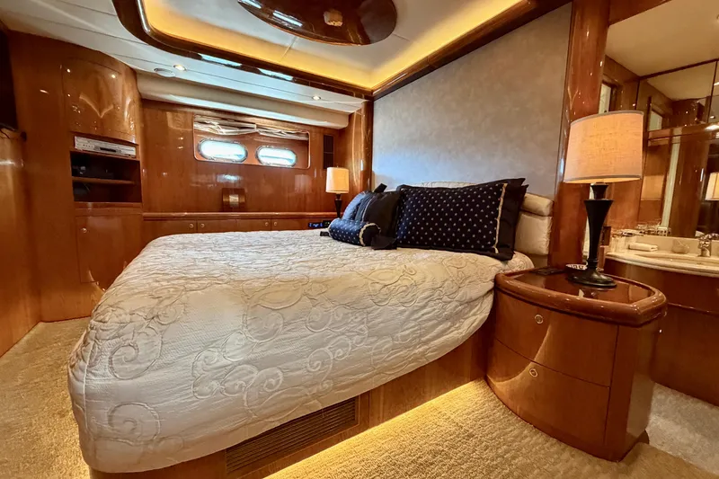 Slide: The Image of Luxurious Horizon 92 yacht bedroom with elegant wood finishes and ambient lighting. - 79