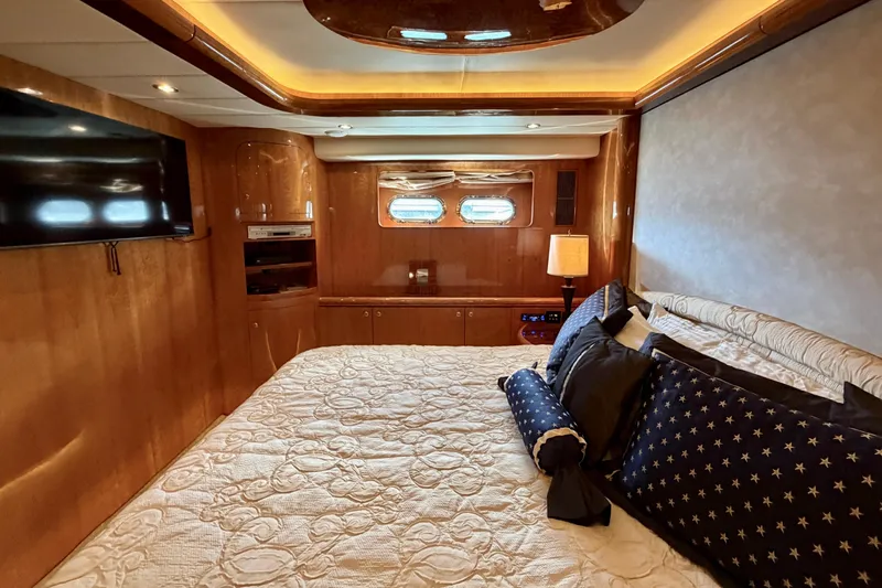 Slide: The Image of Luxurious bedroom interior on Horizon 92 yacht with elegant wood paneling and plush bedding. - 80