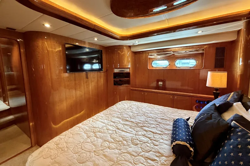 Slide: The Image of Luxurious yacht bedroom with wood paneling, TV, and elegant bedding on Horizon 92. - 81