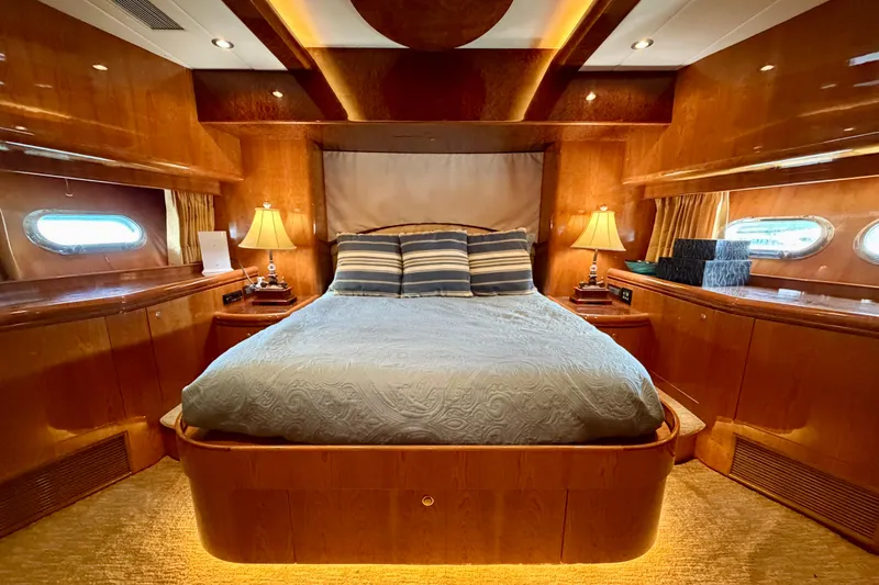 Slide: The Image of Luxurious yacht bedroom with wooden interior, cozy bed, and ambient lighting on Horizon 92. - 82