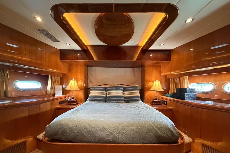 Slide: The Image of Luxurious bedroom interior on Horizon 92 yacht with elegant wood paneling and ambient lighting. - 83