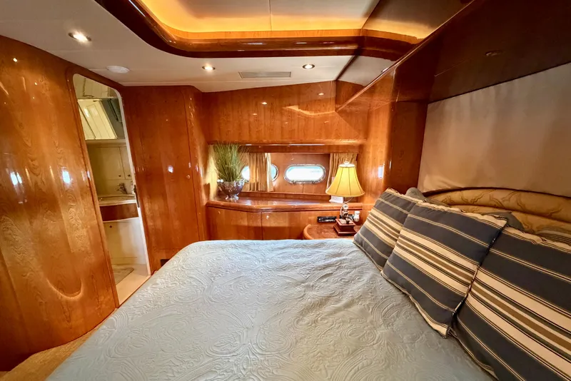 Slide: The Image of Luxurious Horizon 92 yacht bedroom with elegant wood paneling and cozy bedding. - 88