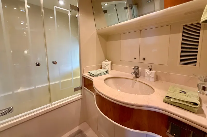 Slide: The Image of Luxurious yacht bathroom with glass shower, elegant sink, and modern fixtures on Horizon 92. - 91