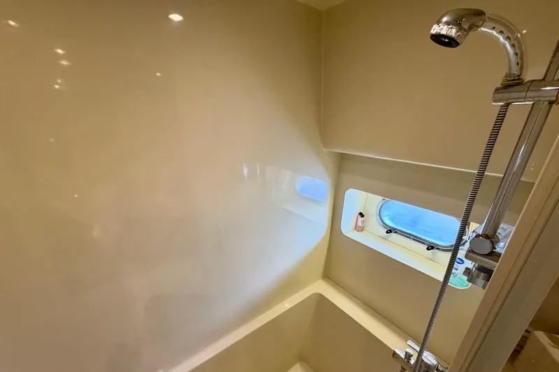 Slide: The Image of Shower area in Horizon 92 yacht with window and chrome fixtures. - 94