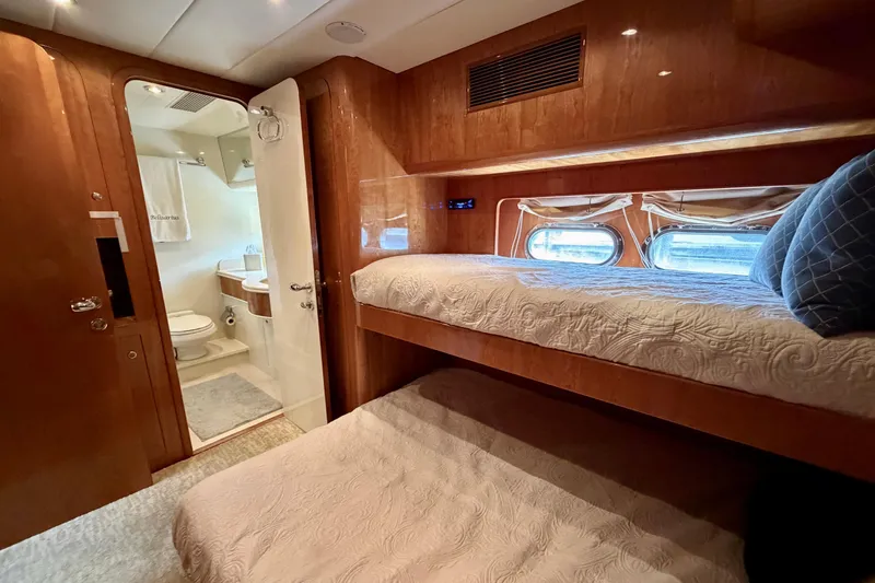 Slide: The Image of Luxurious Horizon 92 yacht cabin with bunk beds and ensuite bathroom. - 99