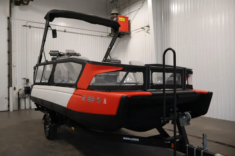 Slide: The Image of 2023 Sea-Doo Switch Sport 21 in a garage, showcasing its sleek design and vibrant colors. - 2