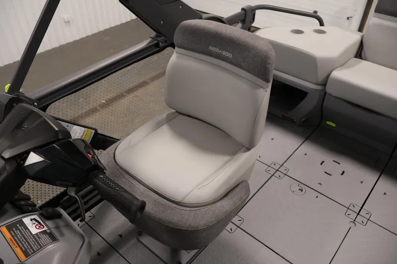 Slide: The Image of 2023 Sea-Doo Switch Sport 21 interior with gray seating and steering controls. - 20
