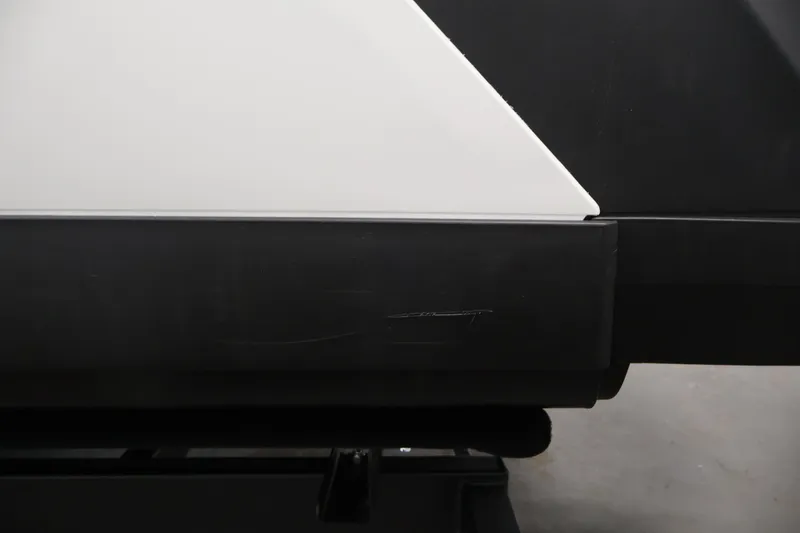 Slide: The Image of Close-up of 2023 Sea-Doo Switch Sport 21 hull detail, featuring sleek black and white design. - 28