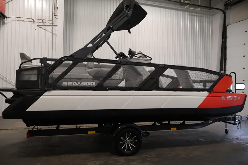 Slide: The Image of 2023 Sea-Doo Switch Sport 21 pontoon boat in a garage setting. - 3
