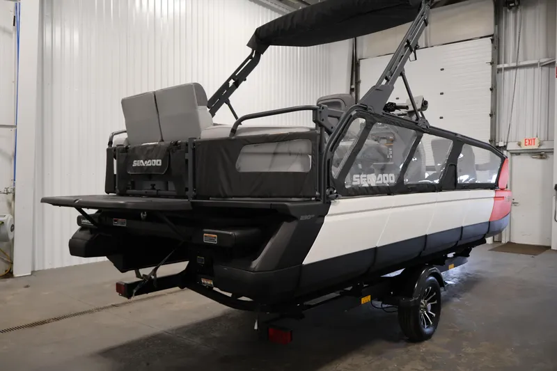 Slide: The Image of 2023 Sea-Doo Switch Sport 21 pontoon boat in a garage setting. - 4