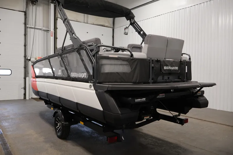 Slide: The Image of 2023 Sea-Doo Switch Sport 21 in a garage, showcasing rear design and seating. - 6