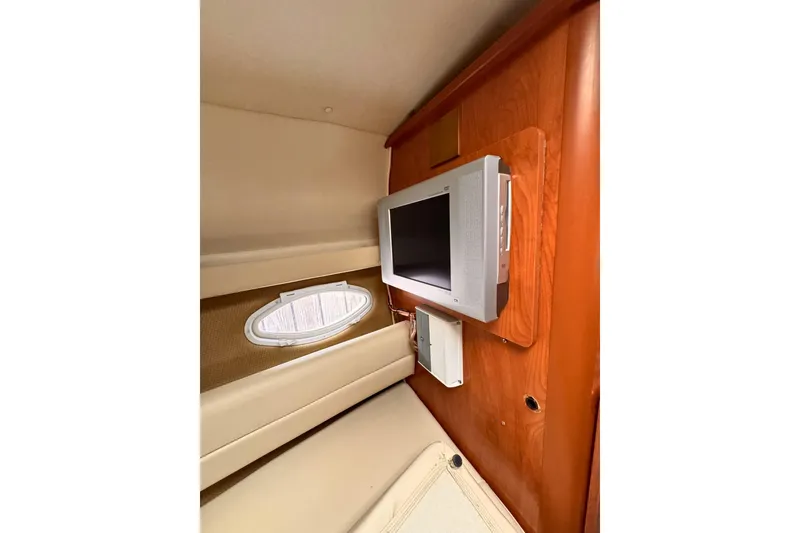 Slide: The Image of Interior of 2007 Rinker 270 Express Cruiser with TV and porthole window. - 10