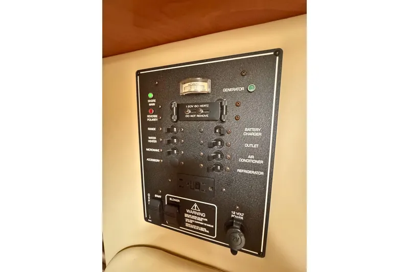 Slide: The Image of Control panel of a 2007 Rinker 270 Express Cruiser boat, featuring various switches and indicators. - 12