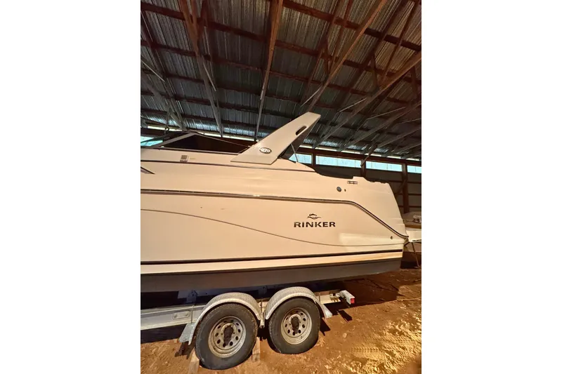 Slide: The Image of 2007 Rinker 270 Express Cruiser boat on trailer in a covered storage area. - 2